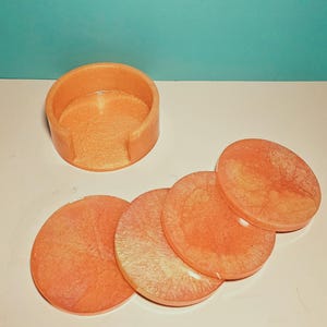orange and yellow round coaster set